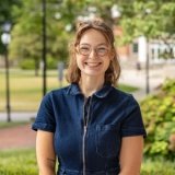 Person wearing glasses and smiling