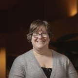 Person wearing glasses and smiling