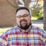 Person wearing glasses and smiling