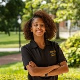 Person wearing Centre Student Life office polo and smiling at camera