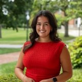 Person wearing red top and smiling at camera