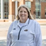 Person wearing Centre College swimming and diving pull over and smiling at camera