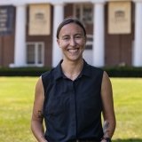 Person wearing black top and smiling at camera