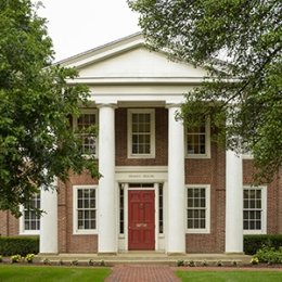 Horky House - historic two story building with columns on porch with red door