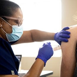 Campus nurse giving a vaccination