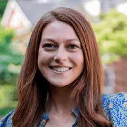 Claire Ansman - lady with long auburn hair with blue paisley shirt