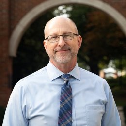 david dewitt - man wearing glasses, blue dress shirt and navy striped tie