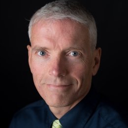 David Anderson - man wearing black dress shirt with green striped tie