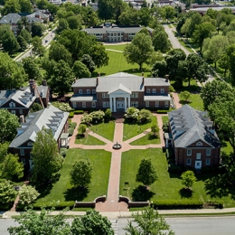 Aerial view of Benefactors Plaza behind Old Centre - aerial view of buildings with fountain in the middle of sidewalks joining together at fountain