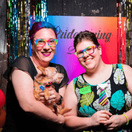 Two Centre employees and a small dog at Pridecoming