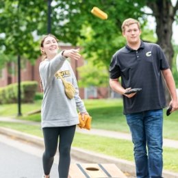 students playing cornhole