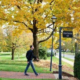 student walking by the Old Centre sign