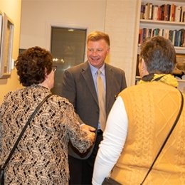 President Moreland shaking hands with people at reception