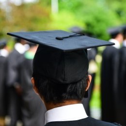 Student standing in line at graduation in cap and gown