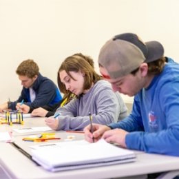 Group of students taking notes in class