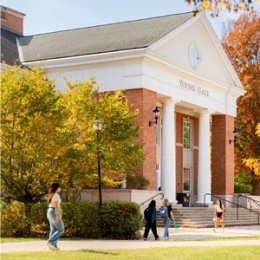Student walking in front of Young building