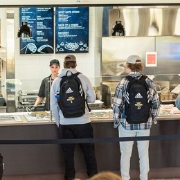Students standing in a food service line