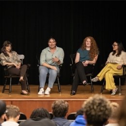 Group of alumni have a panel discussion in front of students