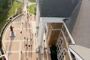 Aerial view of students near campus library with large sidewalks and statue of Abraham Lincoln
