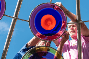 Brook Forrest White, Jr. '91 works on installing a glass disc at the Stephen Powell Memorial Sculpture. White spearheaded the installation of the memorial sculpture and garden, which was dedicated Oct. 15 during Centre College's 2022 Homecoming.