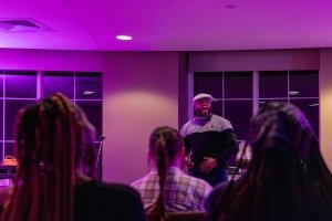 Devine Carama shares an open mic night to kick off Building Bridges and Community Day.