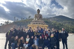 CentreTerm class in Bhutan large group in front of temple statue