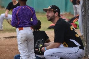 Will Kempf, class of 2024, talks with a young baseball player in the Dominican Republic.