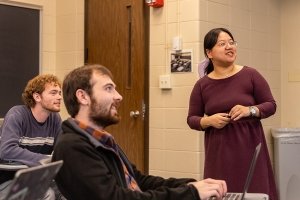 Assistant Professor of Chinese Jingjing Cai (right) teaching with students Kade Schooling (left) and Robbie Harper (center).