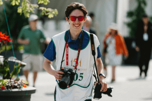 Luke Napier at Churchill Downs with a staff lanyard and two cameras.