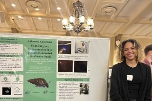 Chloe Hein presenting on her research at the Summer Undergraduate Research Conference.
