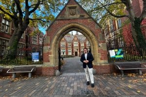 Centre graduate Aiden Jackson poses for a photo in front of a brick archway while he pursues his MBA in England.