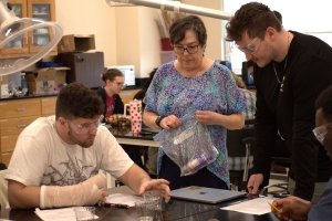 Jennifer Muzyka works with students during an experiment.