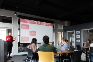 Morgan Cope is presenting to a group of students about Cognative Dissonance. The class is taking place in CentreWorks.