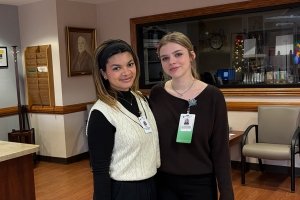 Two students are posing for a photo while volunteering with Ephraim McDowell Health.