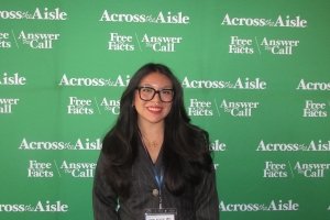 Getzamary Solano in front of an Across the Aisle backdrop during an Ambassador weekend.