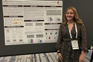 Caroline Toler in front of a poster about her research project.