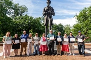 Faculty and staff honored during the end-of-year ceremony pose together outside the Centre College Library.