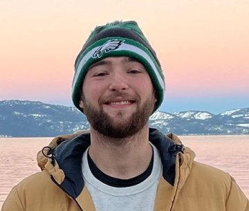 voice_gage-hayden.jpg Centre student Gage Hayden smiling with a lake and snow-capped mountains in background