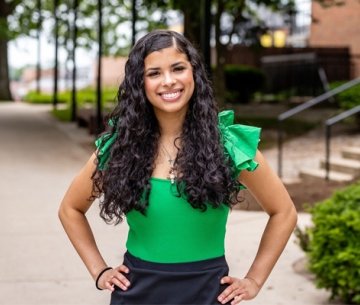 Student wearing green top and black skirt