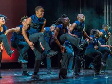 A group of dancers from Step Afrika! on stage