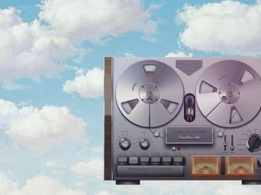 A graphic showing a tape reel against a cloudy sky