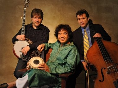 Bela Fleck, Zakir Hussain, and Edgar Meyer holding instruments