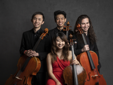 Four members of Galvin Cello Quartet posing for a portrait while holding their cellos