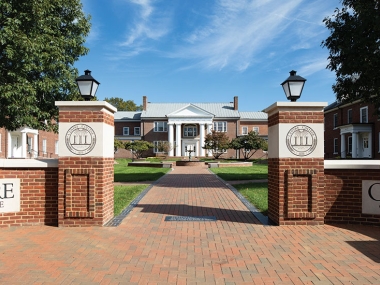 Bright spring photo of brick pathway and entry pillars