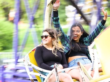 Two students riding a carnival ride