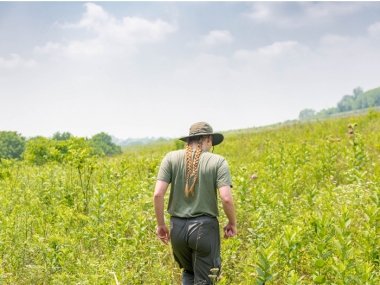 Student walking through field at Shaker Village