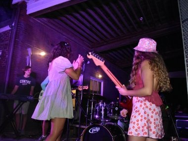 band performing: electric guitar, keyboard, drum kit