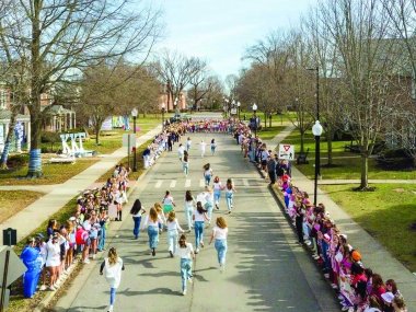 Students running down walnut st on bid day for sororities