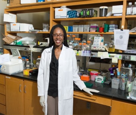 Alumni standing in science lab
