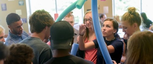 Students collaborating in a building exercise